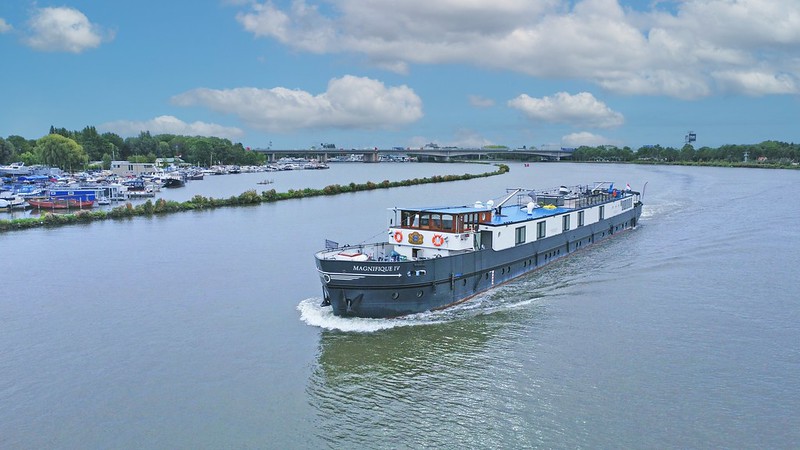 The Magnifique IV drifting down the water offers a luxurious way to travel and view the picturesque Dutch waterways.