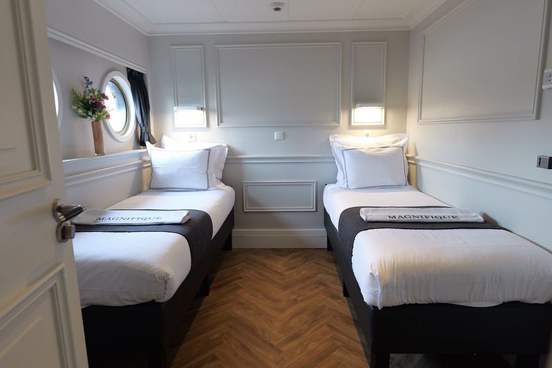 Comfortable beds aboard the privately chartered river barge, Magnifique IV, as it navigates through the picturesque Dutch waterways.