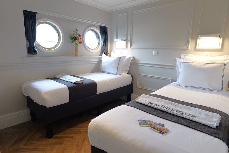 Comfortable beds aboard the privately chartered river barge, Magnifique IV, as it navigates through the picturesque Dutch waterways.