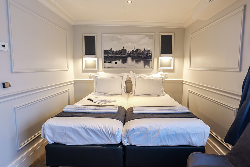 Comfortable beds aboard the privately chartered river barge, Magnifique IV, as it navigates through the picturesque Dutch waterways.