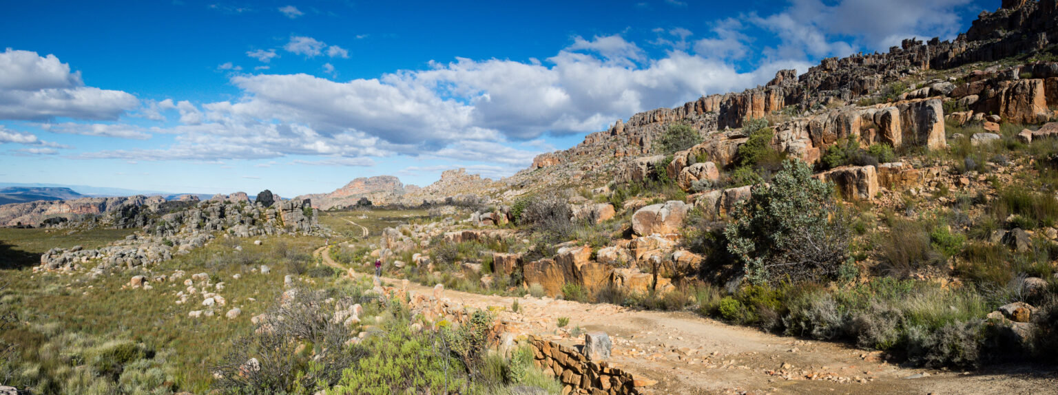 A dirt road winds through rocky outcrops in the Cederberg Wilderness Area, South Africa