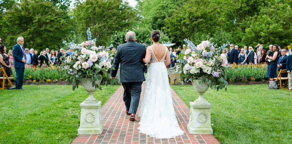 River Farm in Alexandria, Virginia is the ideal event venue for an outdoor event surrounded by beautiful gardens. The brick pathway makes a picturesque runway for brides.