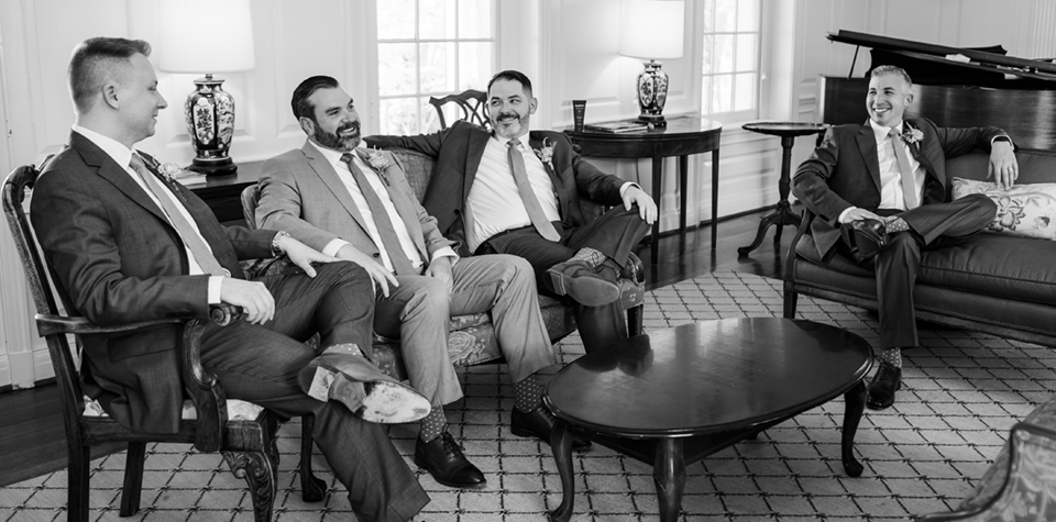 An intimate moment between the groomsmen before the wedding in The Parlor at River Farm.