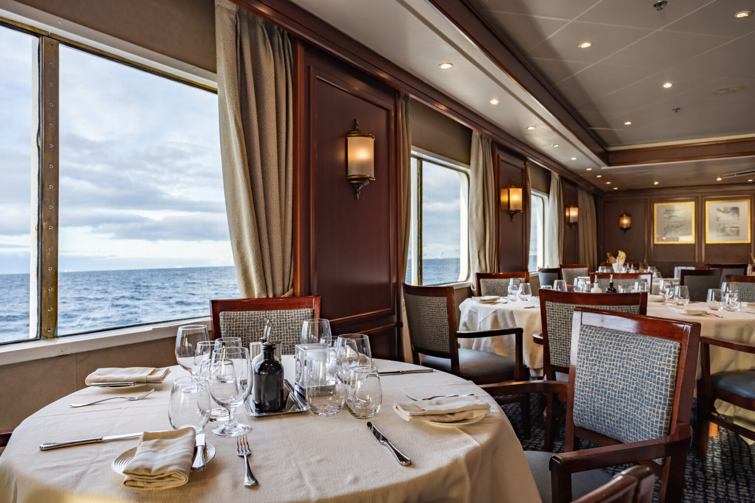 The dining room has luxurious seating and impeccable views aboard Exploris One