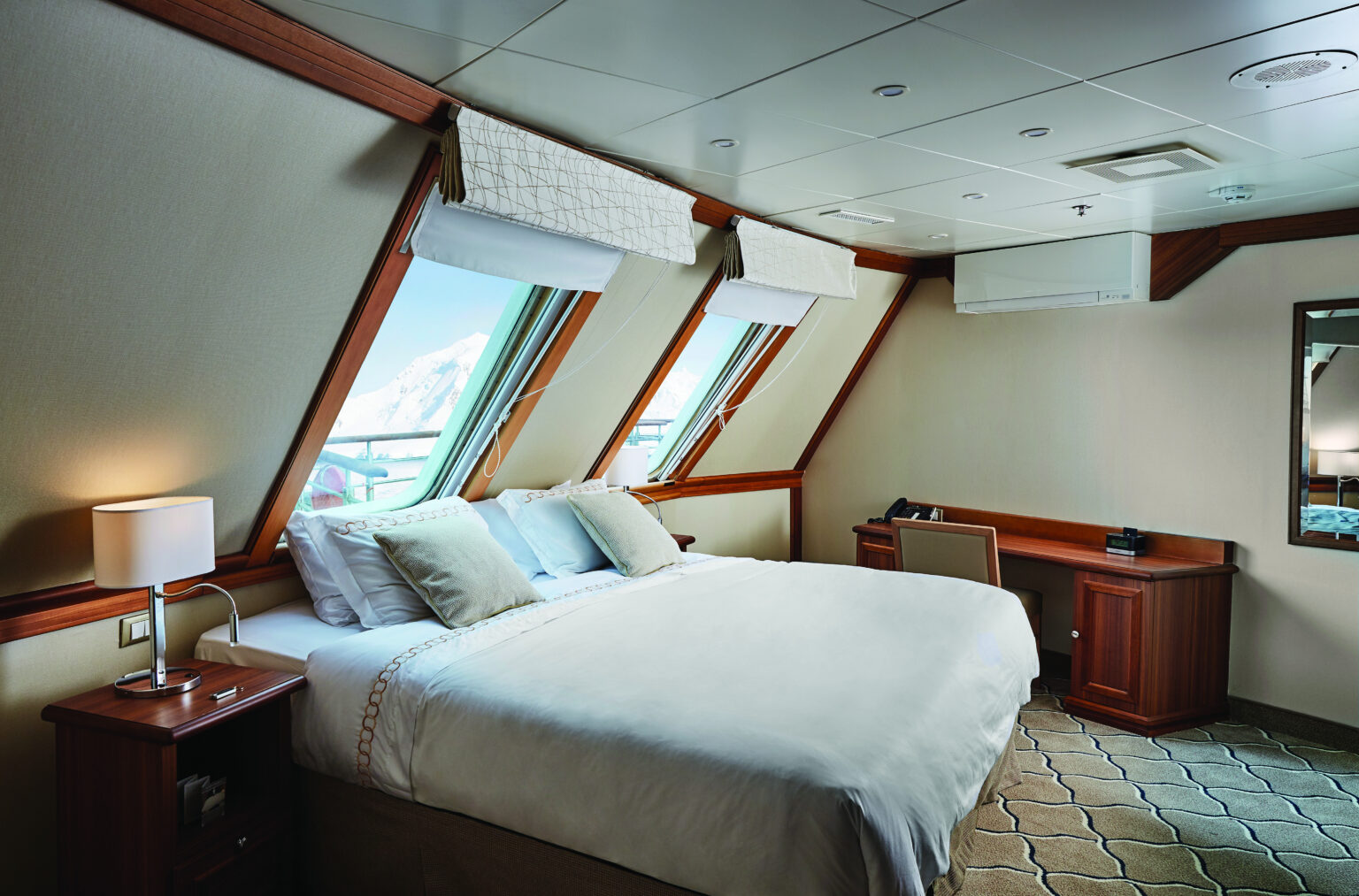 Explore the gardens of Scotland, Norway, and Orkney Islands with the American Horticultural Society aboard Exploris One. Each luxury room has comfortable beds and picturesque views.