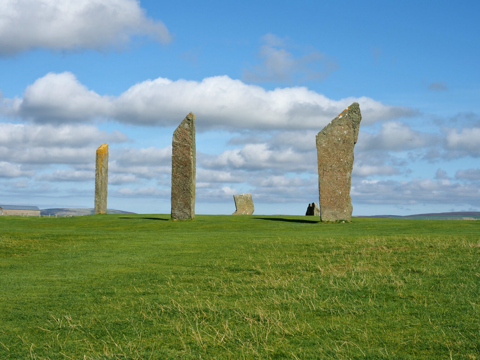 Neolithic monument of tall stones and an angled tip at the Orkney Islands.