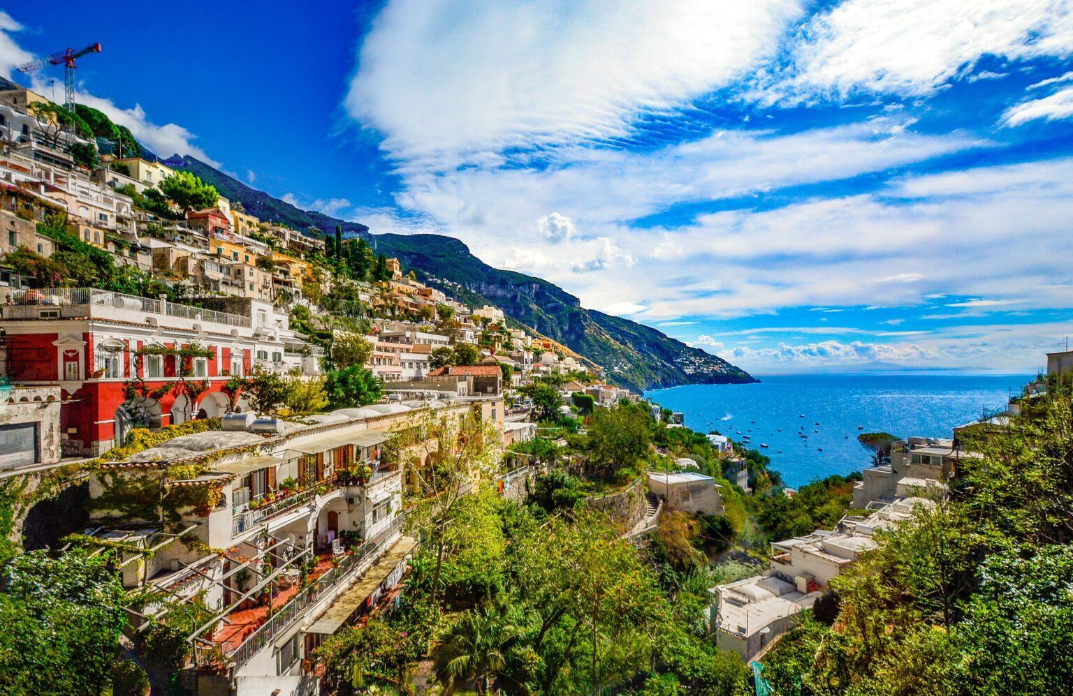 Positano village, a colorful hillside town on the Amalfi Coast, featuring steeply stacked buildings, vibrant Mediterranean architecture, and stunning sea views.