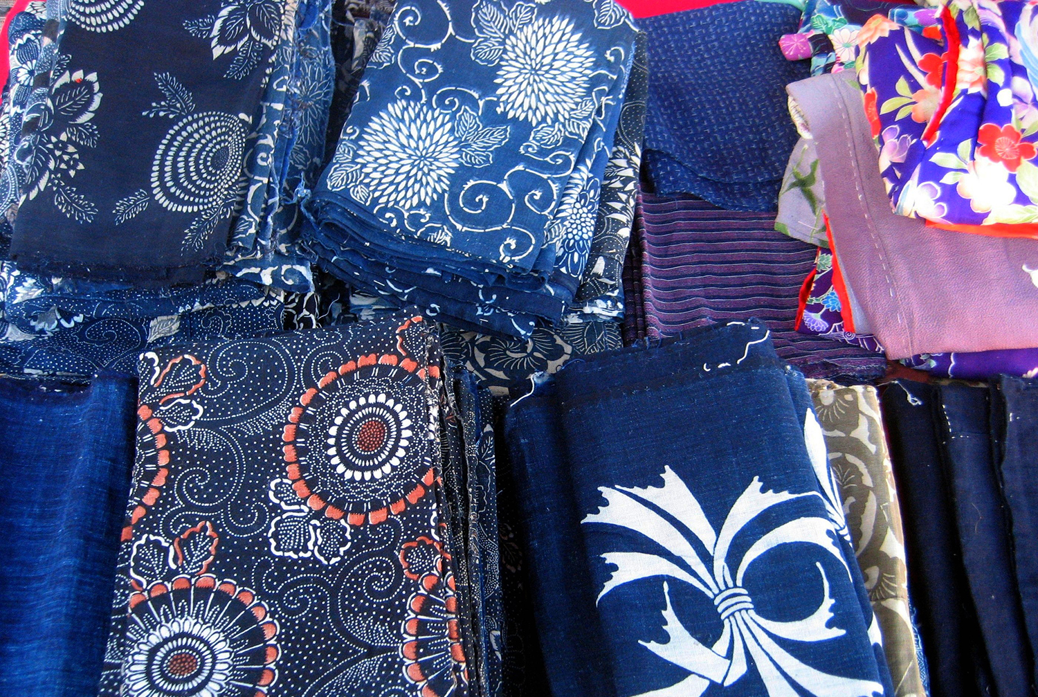 a large selection of Japanese indigo dyed fabric of bright vibrant colors and patterns