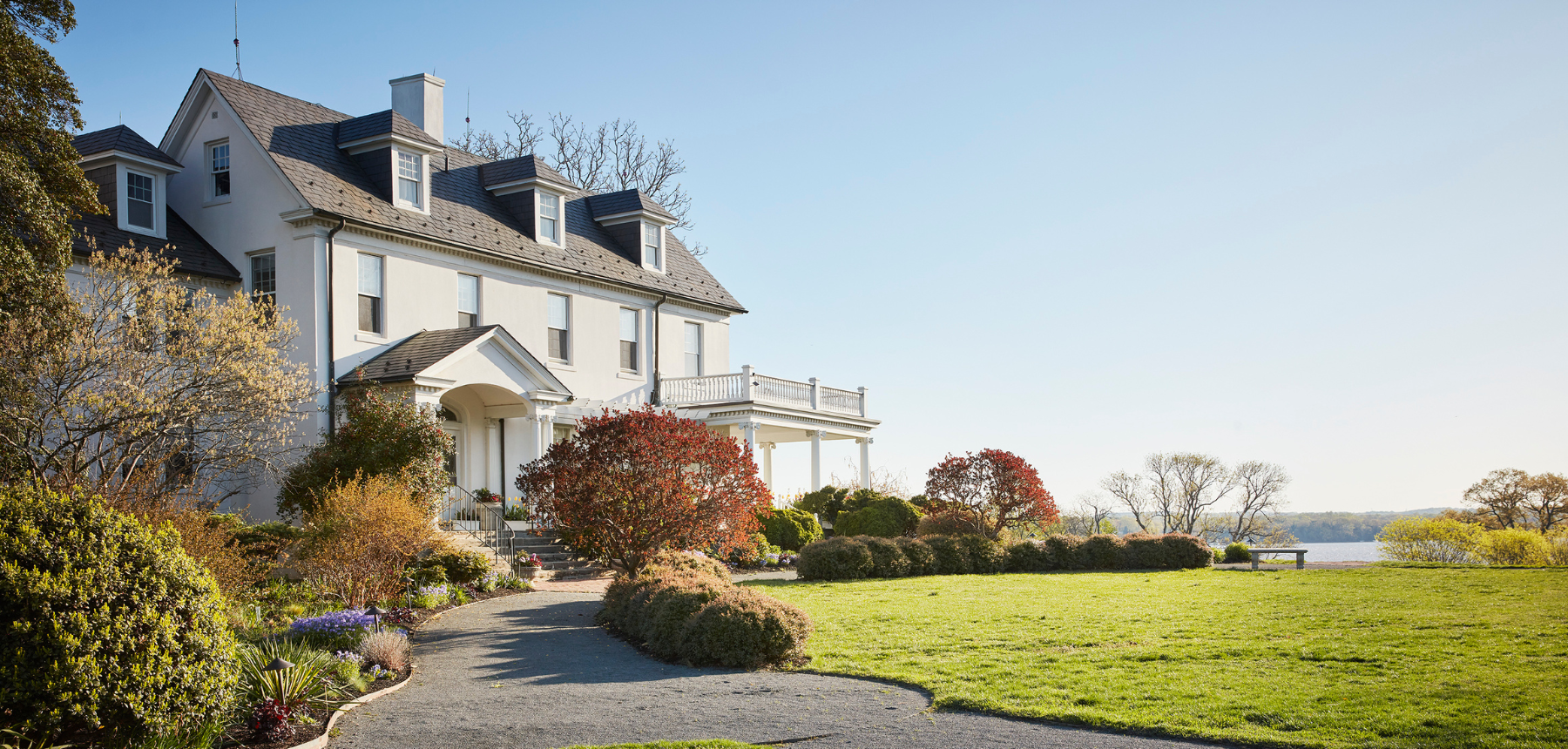 A white house next to a green lawn.