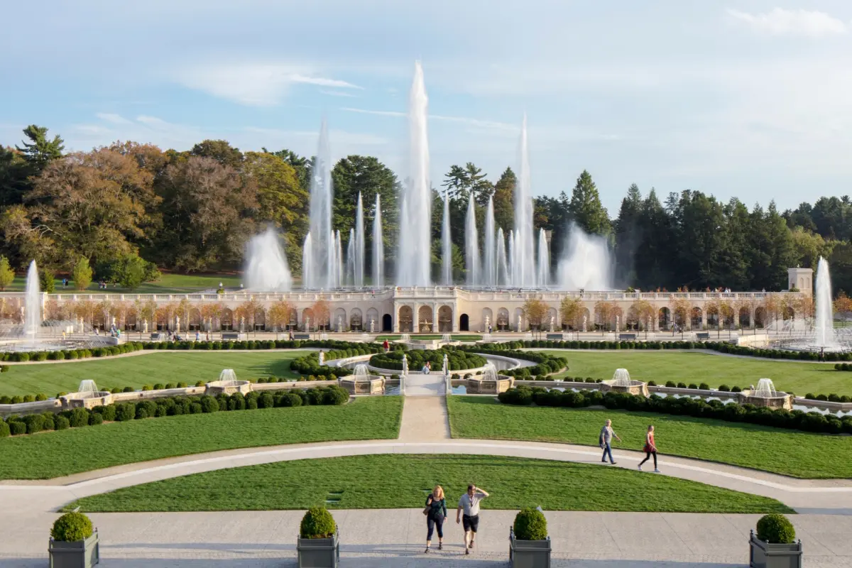 Dramatic fountains spraying water into the air in a formal setting at Longwood Gardens.